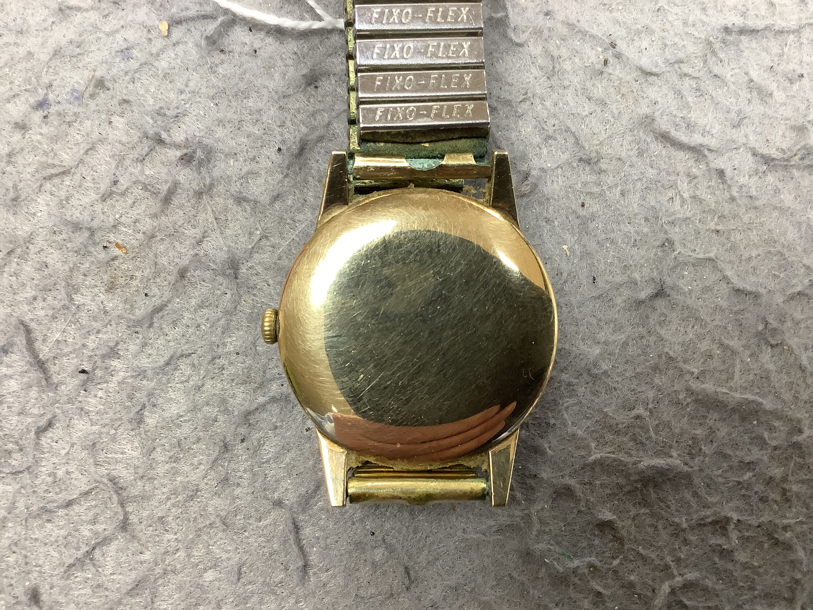 A gentleman's yellow metal Tudor Royal manual wind wrist watch, with baton numerals, on an associated flexible strap, with Tudor box.